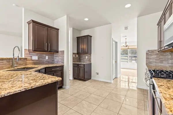 a kitchen with stainless steel appliances granite countertop a refrigerator and a sink