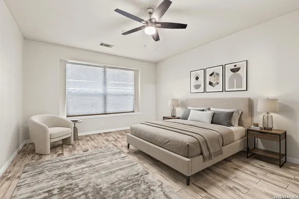 a bedroom with a bed and chair