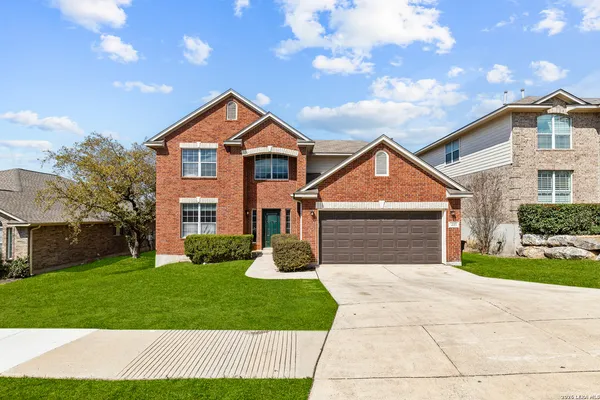 a front view of a house with yard and garage