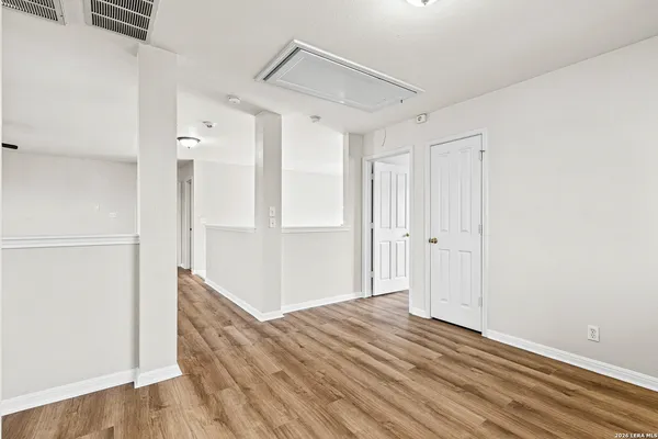 a bedroom with a bed a couch and a potted plant