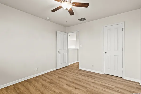 a spacious bedroom with a bed and a couch