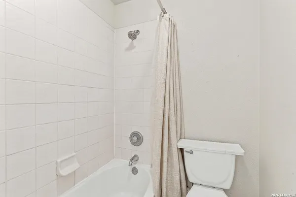 a spacious bedroom with a bed and a couch