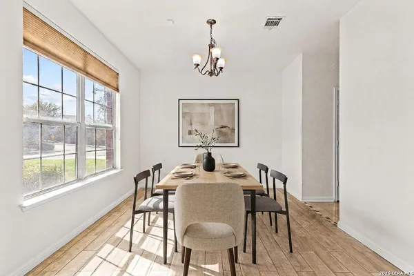 a dining room with furniture a window and wooden floor