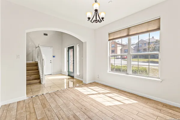 a view of a room with wooden floor and windows