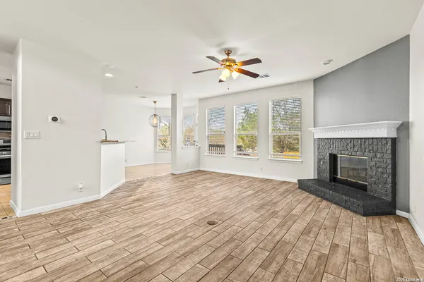 a view of empty room with a fireplace and wooden floor