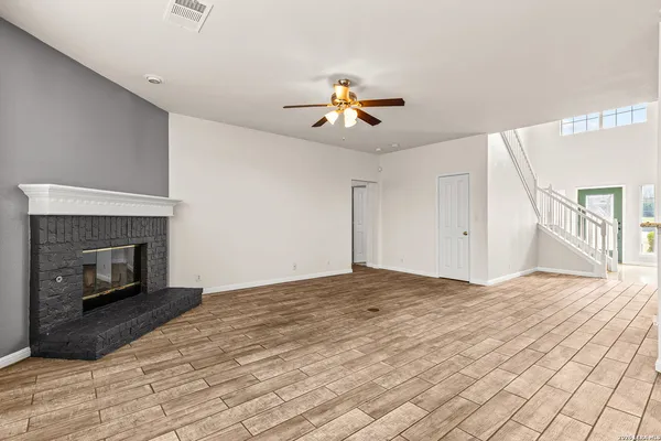 a view of empty room with fan and fireplace