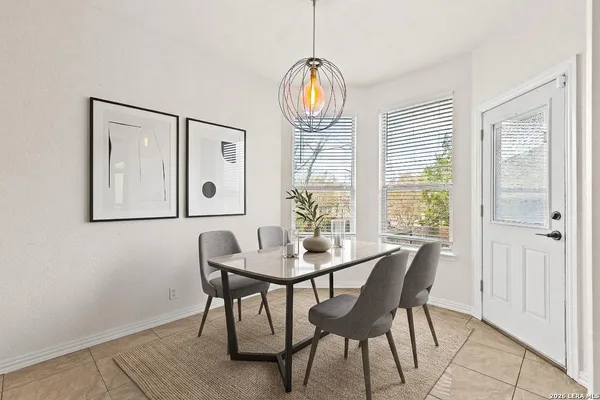 a dining room with furniture window and wooden floor