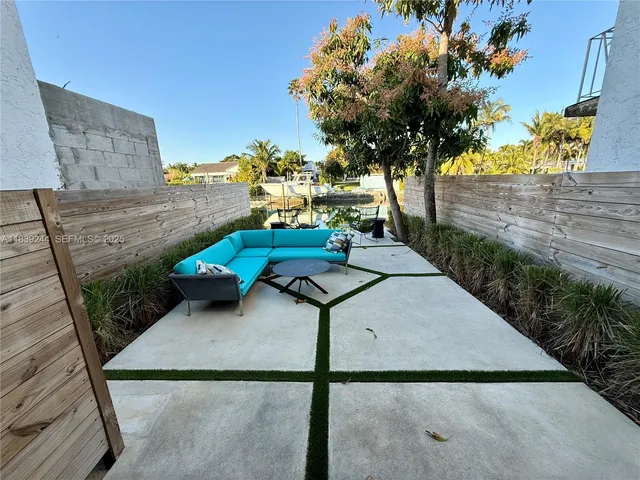 a view of a backyard with sitting area