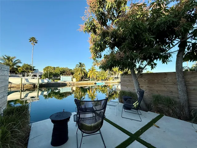 a view of a chairs and table in patio