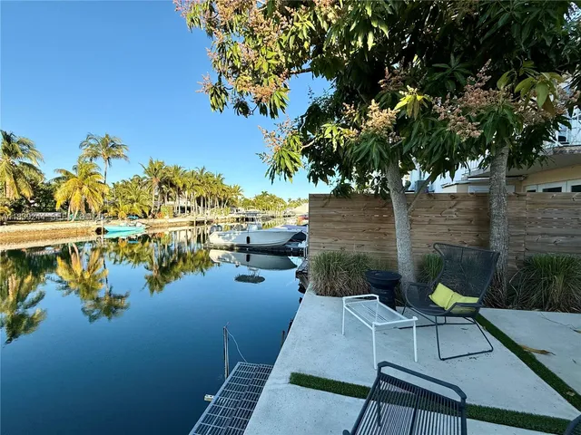 a view of a lake with couches and wooden floor