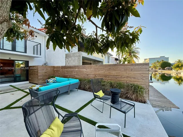 a view of a chairs and table in patio