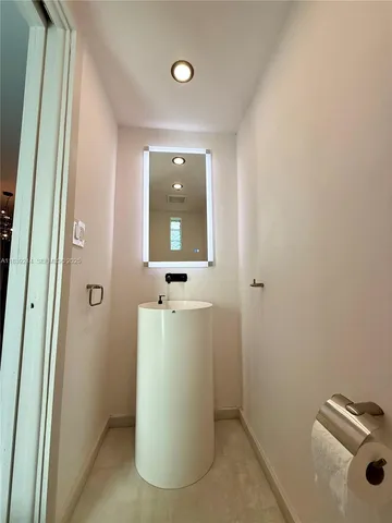 a bathroom with a sink and mirror