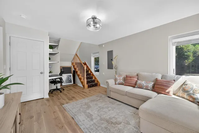 a living room with furniture and wooden floor