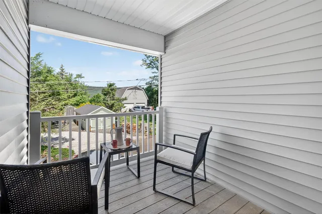 a view of a balcony with furniture