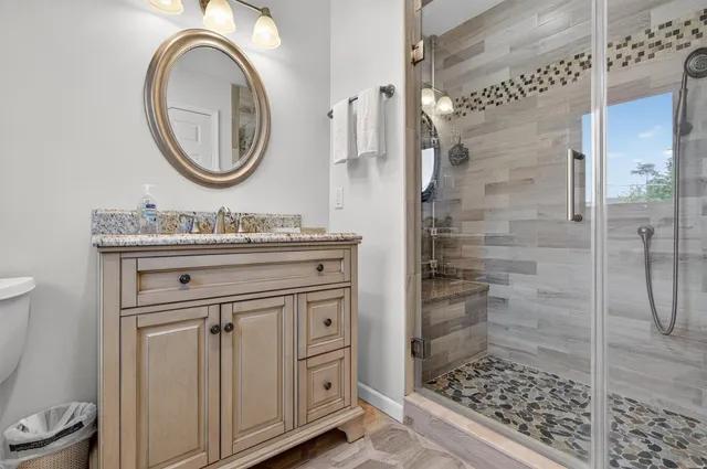 a bathroom with a sink a toilet and a mirror