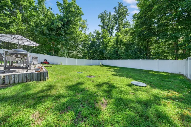 a view of yard with swimming pool and green space