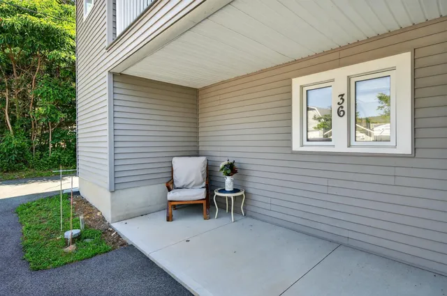 a view of a patio with table and chairs with wooden fence and plants