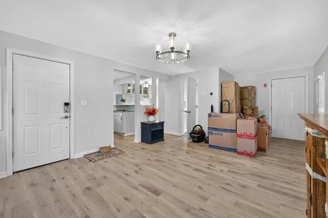 a living room with furniture and a chandelier