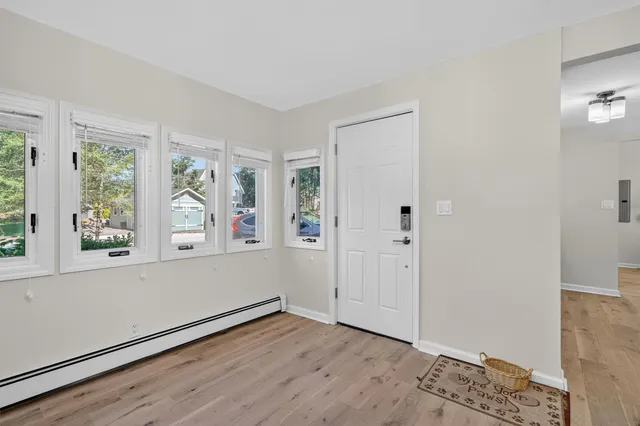 wooden floor in an empty room with a window