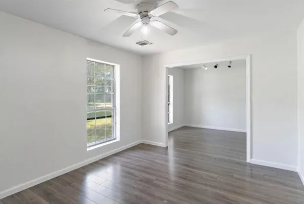 wooden floor in an empty room with a window