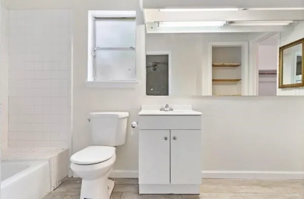 a bathroom with a sink a toilet and bathtub