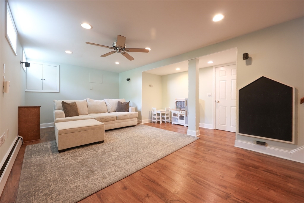 61 Colwell Drive Dedham, MA 02026 - Photo 25 of 32 a living room with furniture and a flat screen tv