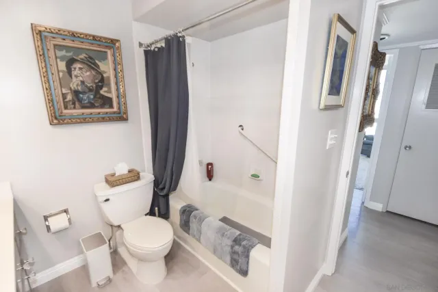 a white toilet sitting next to a bathroom sink