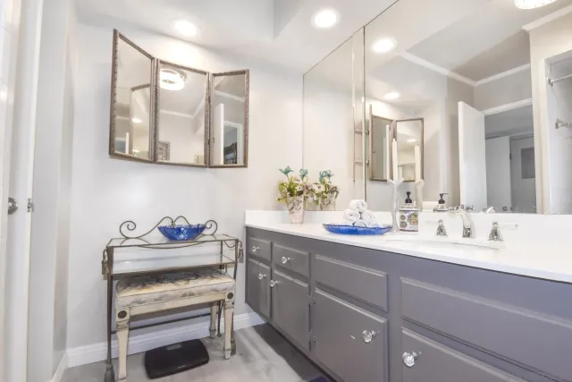 a bathroom with a sink mirror and