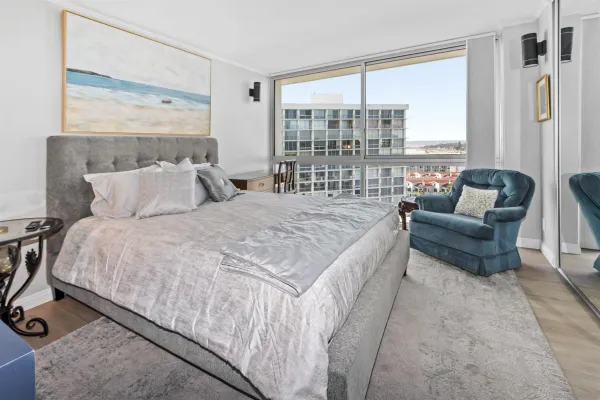 a bed sitting in a bedroom next to a window