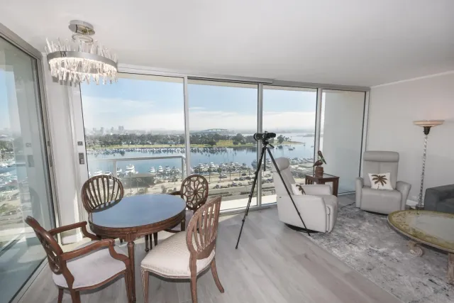 a view of a dining room with furniture a chandelier and wooden floor