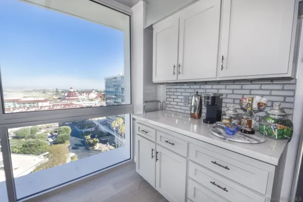 a kitchen with stainless steel appliances granite countertop a stove and white cabinets