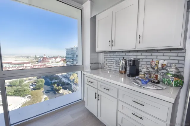 a kitchen with stainless steel appliances granite countertop a stove and white cabinets