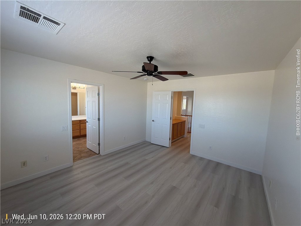 2388 Rue Bienville Way Henderson, NV 89044 - Photo 9 of 16 A quiet bedroom offers an adjoining bath and contemporary wood-look flooring.