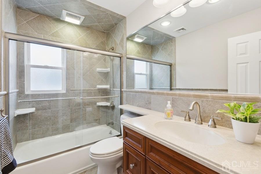 34 South Cliff Road Colonia, NJ 07067 - Photo 12 of 29 a bathroom with a sink a mirror a bathtub and a shower