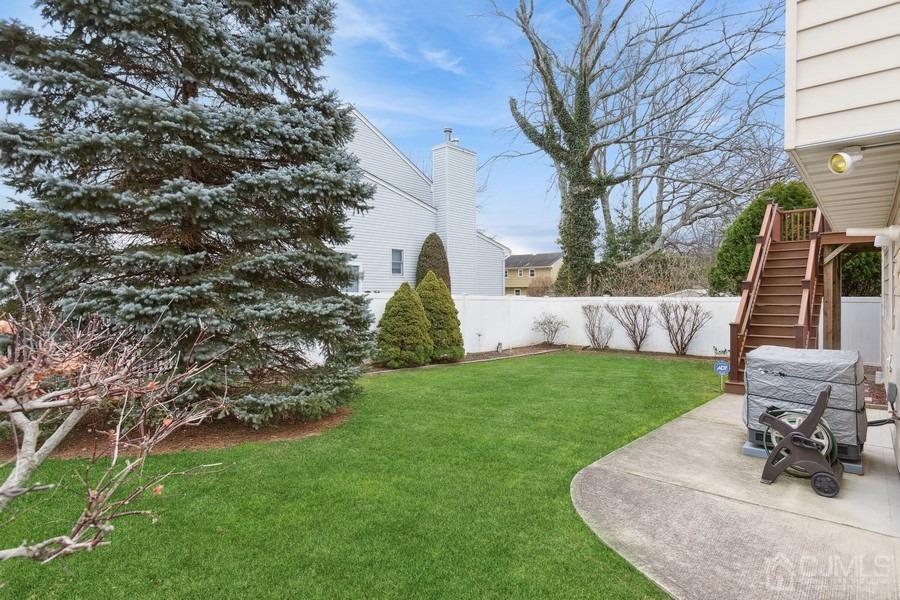 34 South Cliff Road Colonia, NJ 07067 - Photo 19 of 29 a view of a backyard with couches plants and large tree