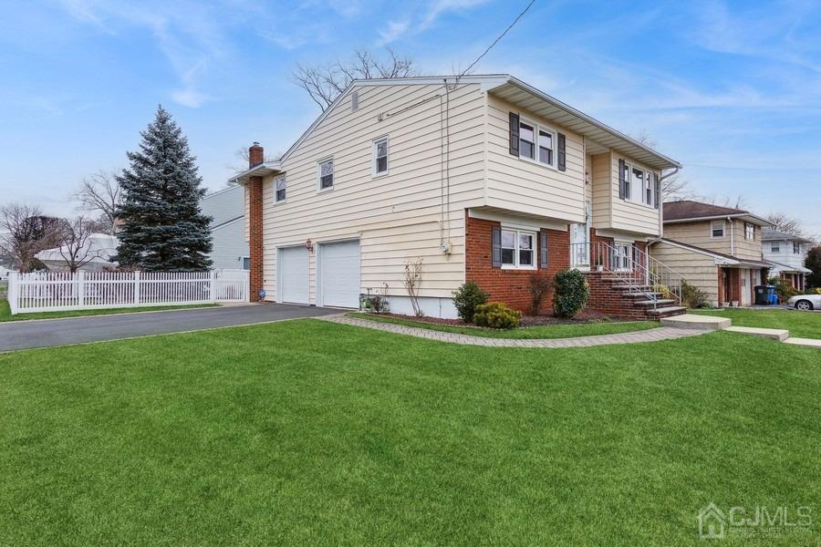 34 South Cliff Road Colonia, NJ 07067 - Photo 2 of 29 a front view of a house with a garden and yard