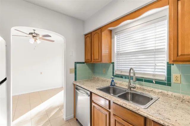a kitchen with a sink a granite counter top and a window