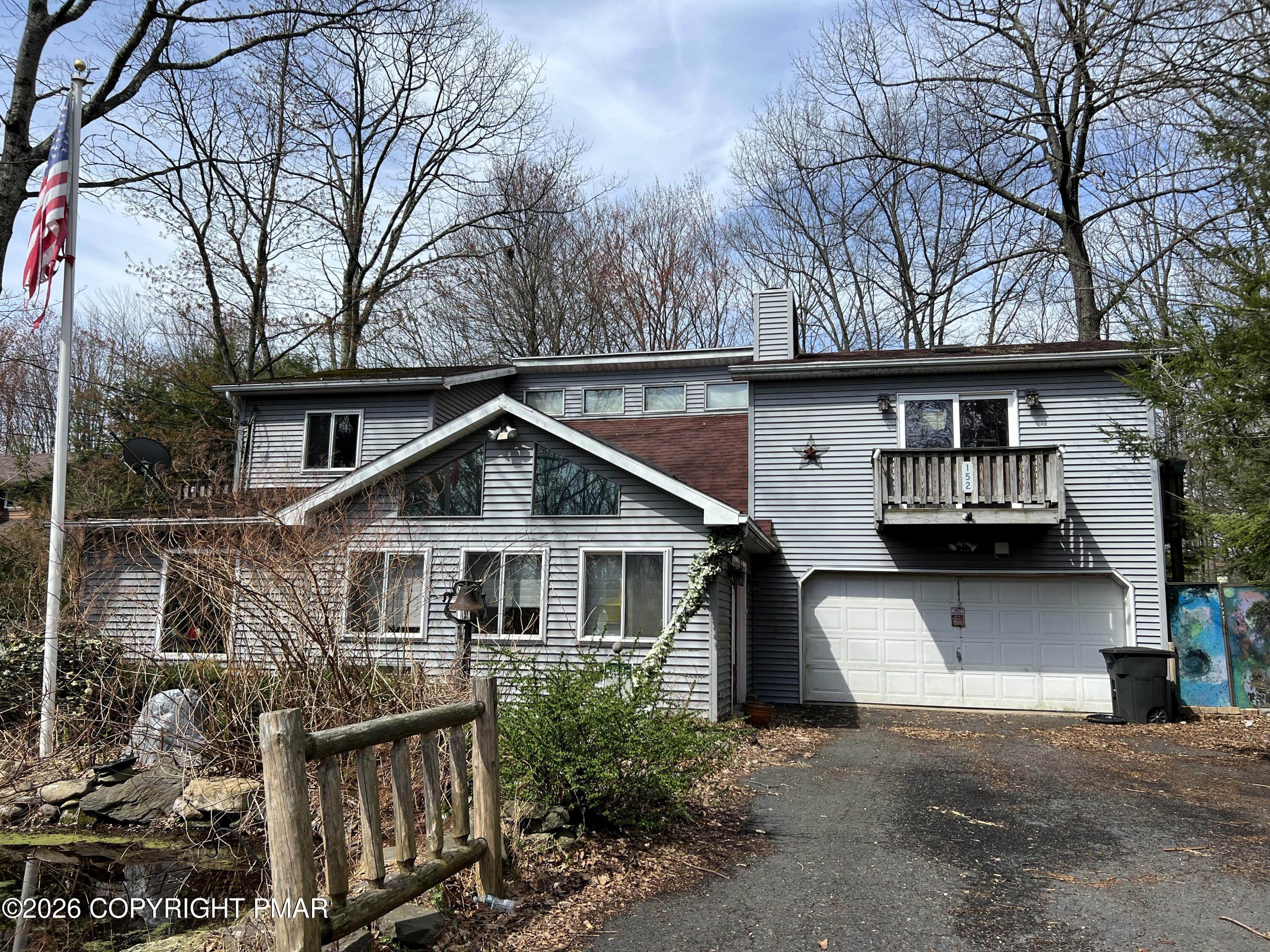 a house that has a tree in front of the house