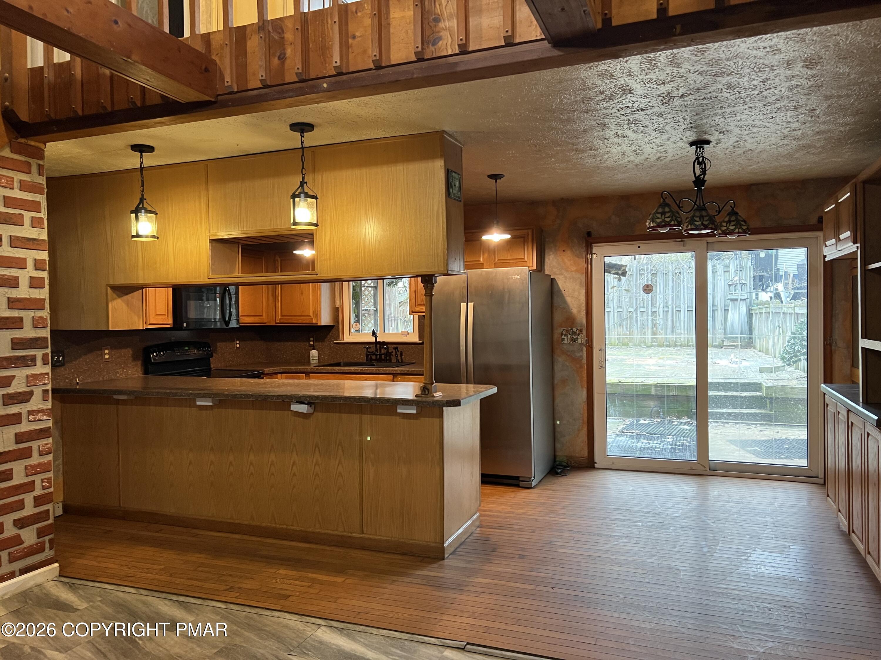 152 Fairview Avenue Mount Pocono, PA 18344 - Photo 15 of 27 a kitchen with stainless steel appliances granite countertop a refrigerator a sink and a wooden floors