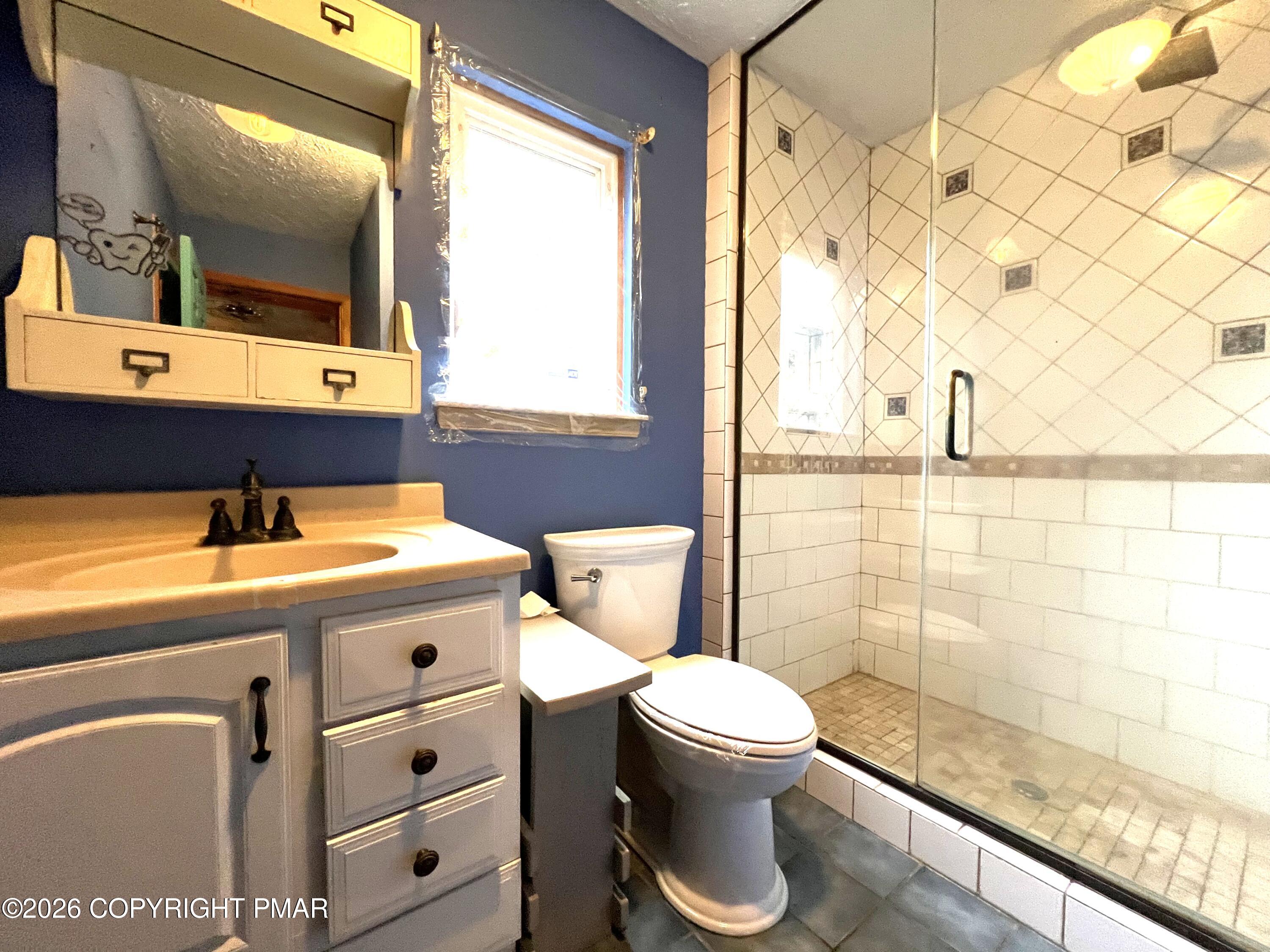 152 Fairview Avenue Mount Pocono, PA 18344 - Photo 18 of 27 a bathroom with a sink a toilet and mirror