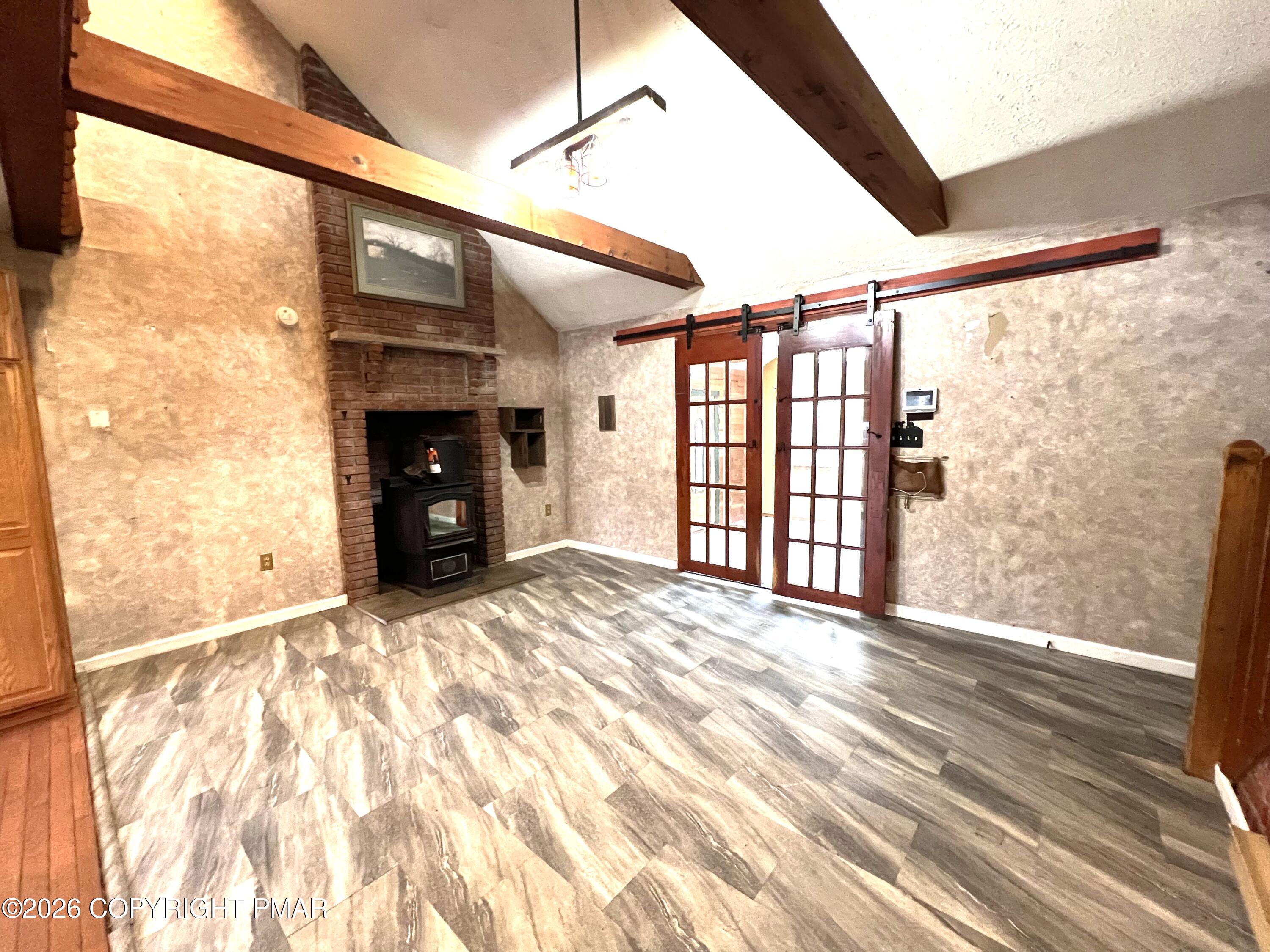 152 Fairview Avenue Mount Pocono, PA 18344 - Photo 6 of 27 a view of empty room with a fireplace and windows