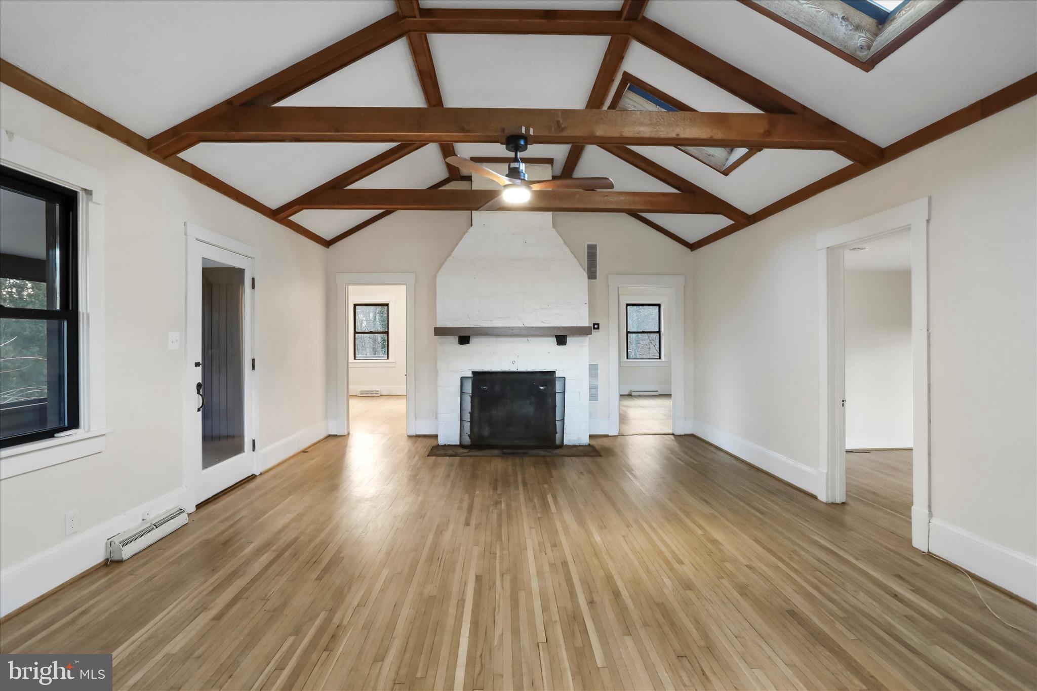84 Funk Road Strasburg, VA 22657 - Photo 11 of 45 a view of an empty room with wooden floor fireplace and a window