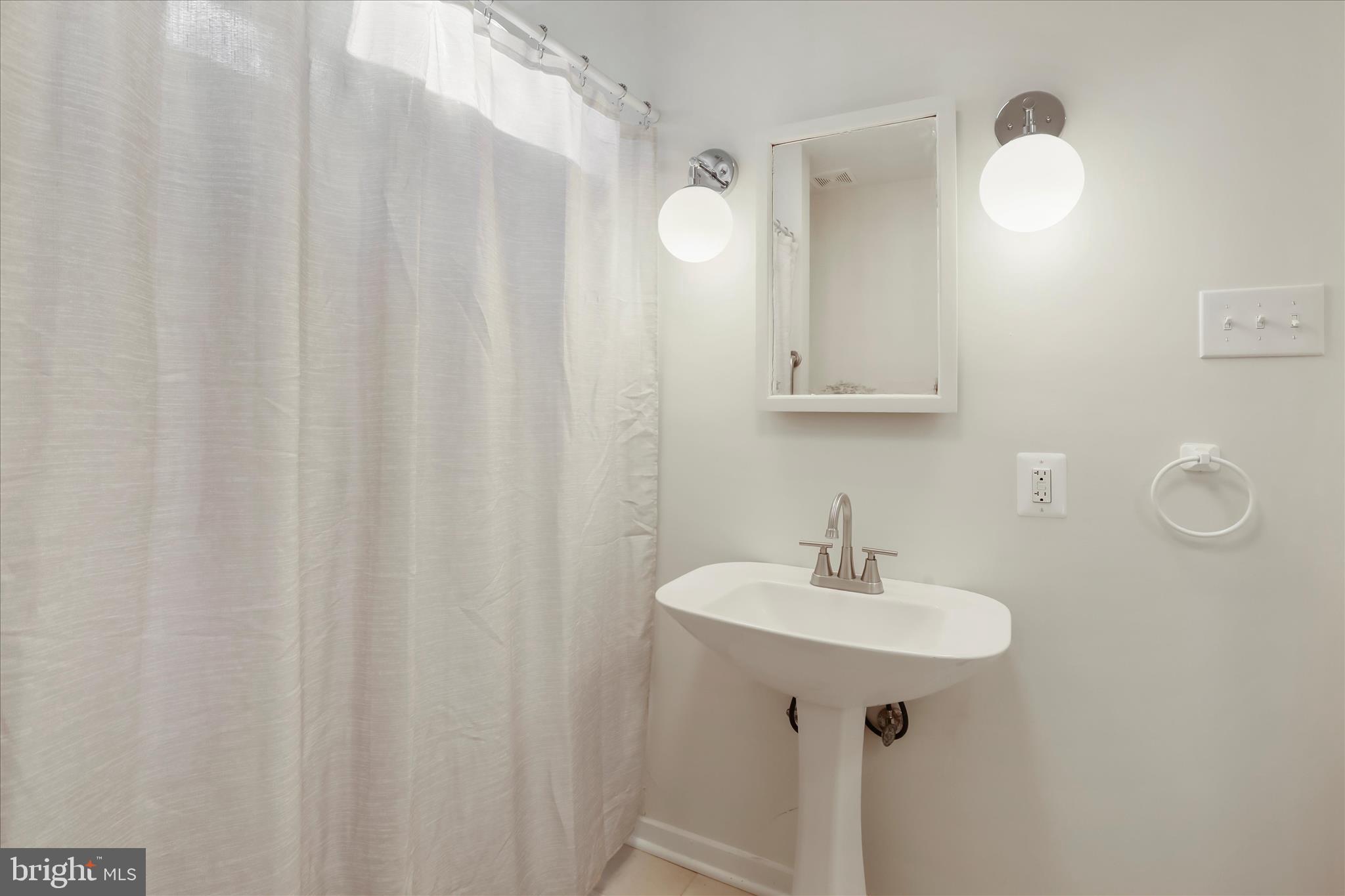 84 Funk Road Strasburg, VA 22657 - Photo 12 of 45 a bathroom with a sink a mirror and a shower curtain