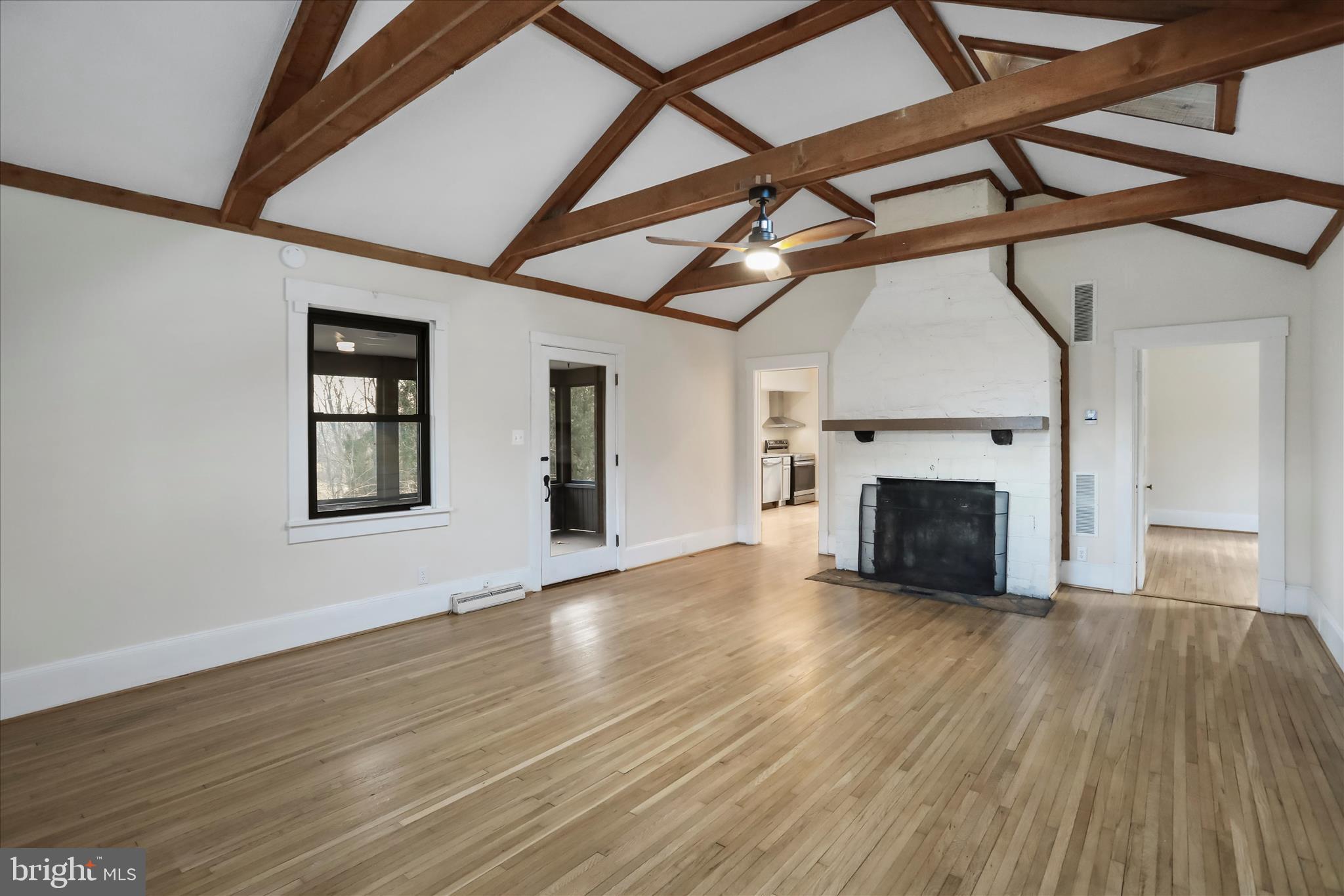 84 Funk Road Strasburg, VA 22657 - Photo 10 of 45 a view of an empty room with wooden floor fireplace and a window