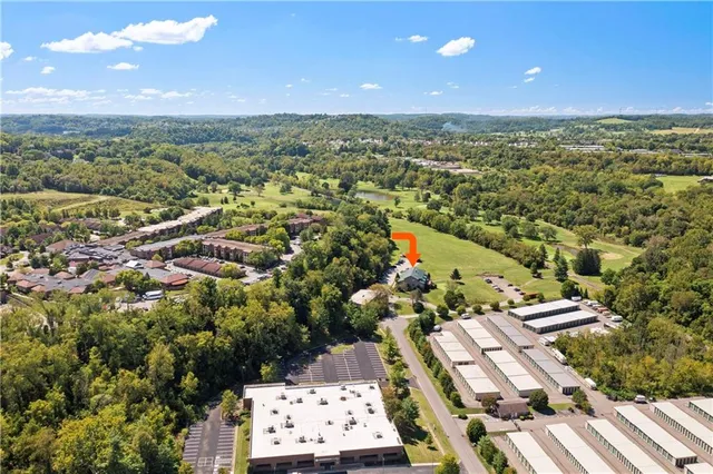 an aerial view of a house with a lake view
