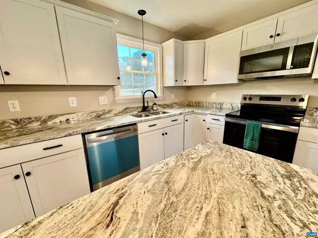 a view of a bathroom with a tub shower and a sink