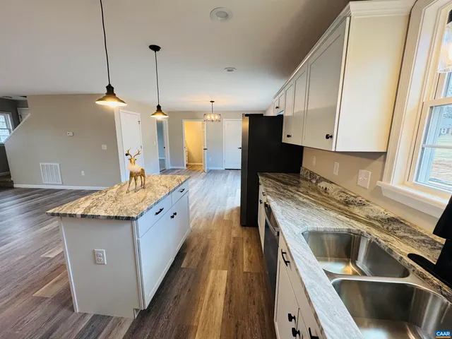 an empty room with a ceiling fan and a window