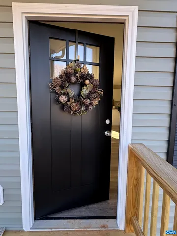 a kitchen with granite countertop a sink stainless steel appliances and white cabinets