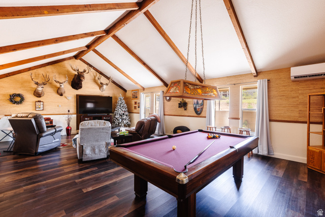 1470 Redwood Tree Street St. George, UT 84790 - Photo 7 of 53 Vaulted ceilings with exposed wood beams define this expansive space, featuring wood-finish flooring, multiple windows, and a wall-mounted air conditioning unit