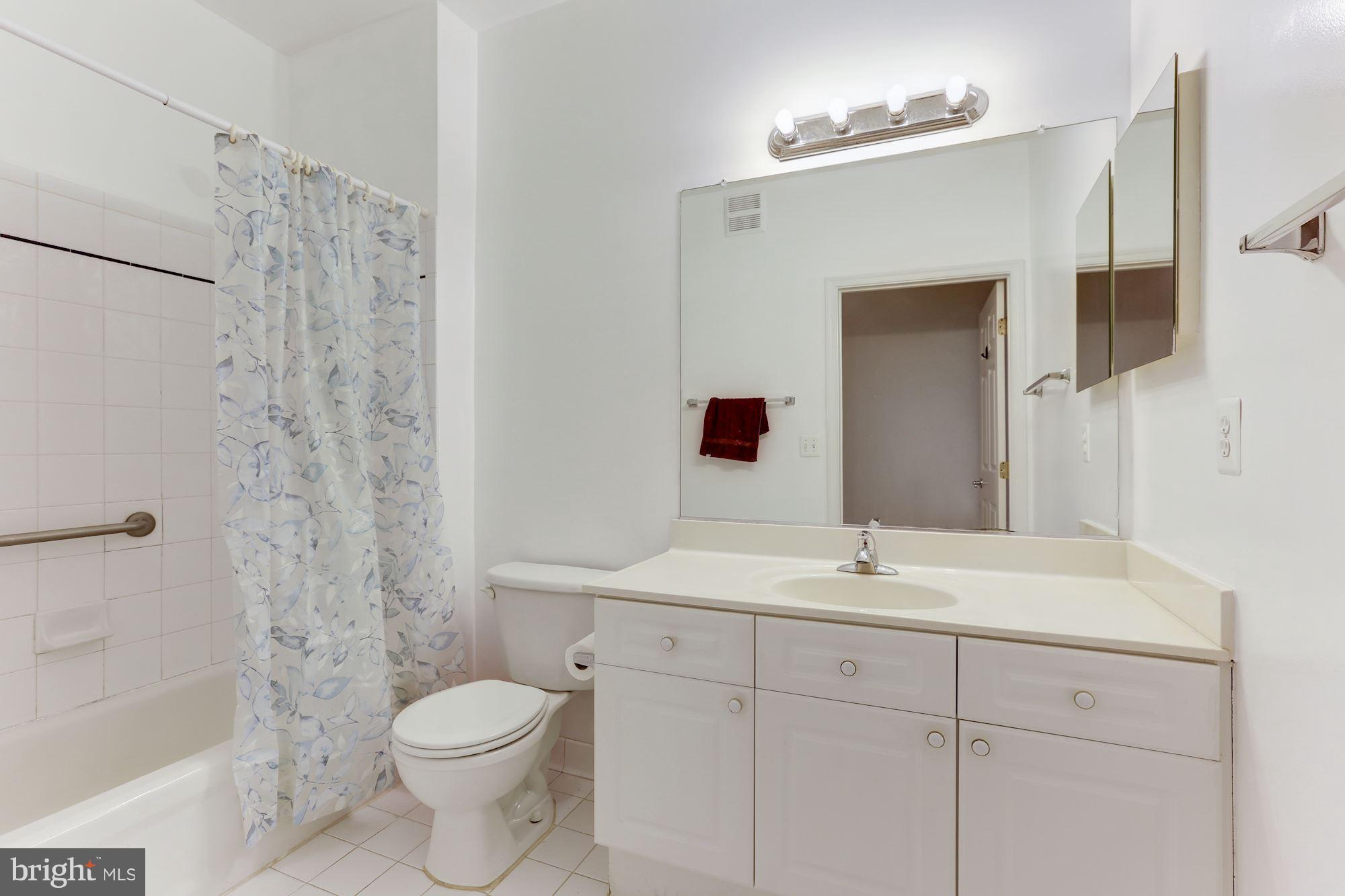 4330 Cannon Ridge Court, Unit 21 Fairfax, VA 22033 - Photo 11 of 24 a bathroom with a sink toilet a mirror and shower